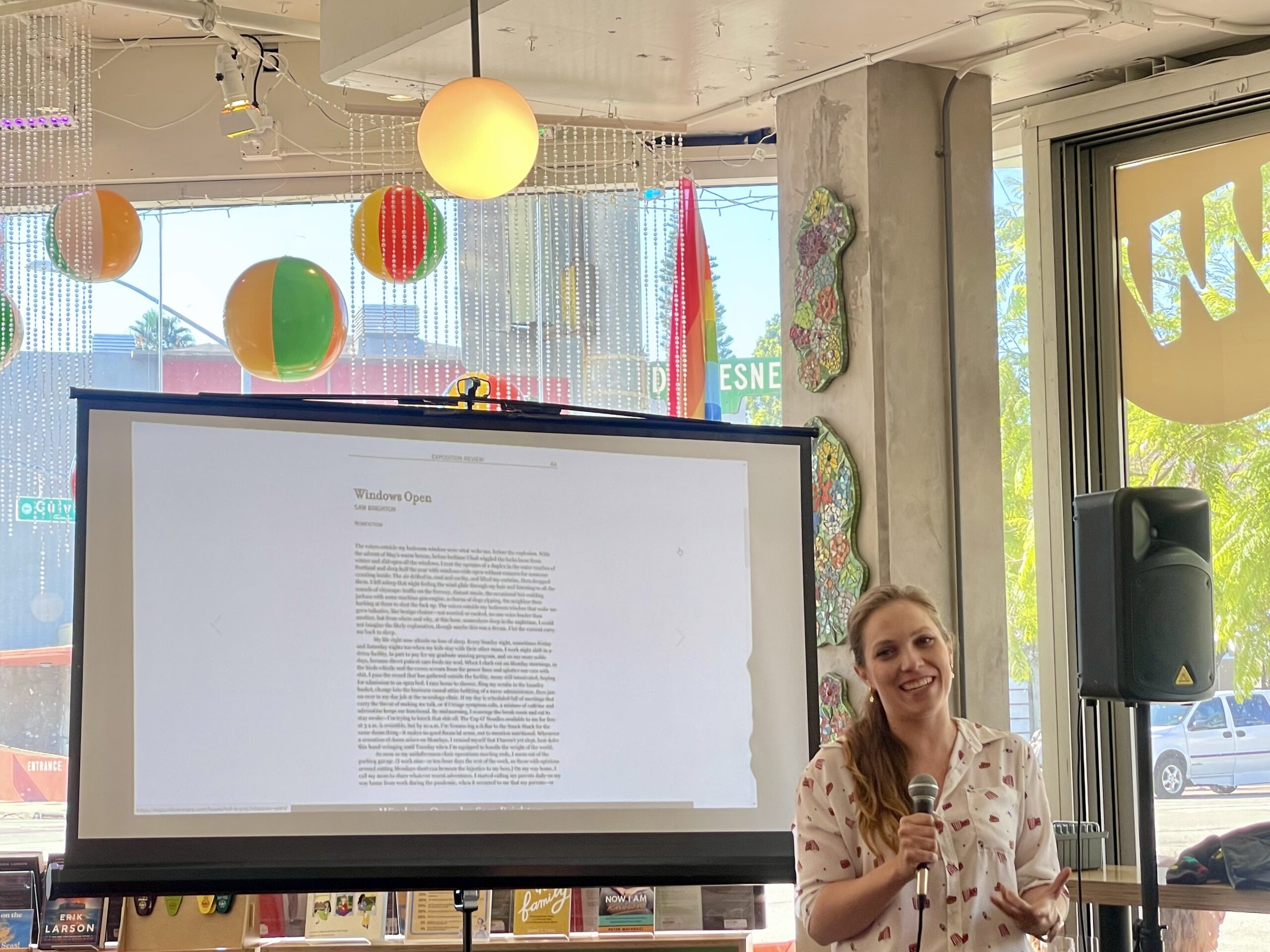 Laura Rensing welcomes guests to the POP reading and launch party